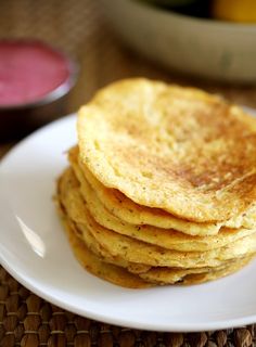 a stack of pancakes sitting on top of a white plate