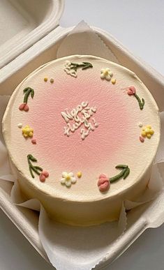 a cake in a box with flowers on it