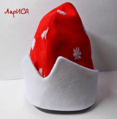 a red and white hat with snowflakes on it