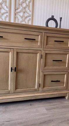 a large wooden dresser sitting on top of a hard wood floor