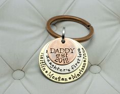 a keychain with three different names on it and a ring attached to it