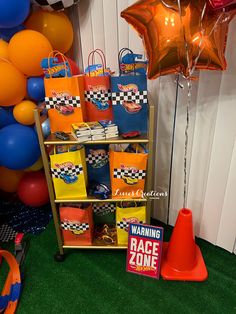 there are many bags and balloons on the shelf next to each other at this birthday party