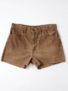 A pair of vintage Levi's corduroy cut-off shorts. Mossy brown corduroy shapes the shorts with soft, frayed hems. They feature a zipper fly and white tab backs. We love them paired with tights! CONDITION In good condition with wear consistent with age and use.  Fraying hems.  MEASURED SIZE: 33 MEASUREMENTS Waist:    33" ...       83.8 cm Inseam: 3"         ...           7.6 cm Rise:     12"       ...            30.5 cm Hips:     42"    ...    106.7 cm For best fit, please compare measurements wit Brown High-waisted Cotton Shorts, Vintage Brown Cotton Shorts, Brown High-waisted Corduroy Shorts, Brown High Waist Corduroy Shorts, High Waist Brown Corduroy Shorts, Brown Cutoff Shorts For Summer, Summer Cutoff Brown Shorts, Brown Corduroy Shorts With Pockets, Vintage Cutoff Cotton Shorts