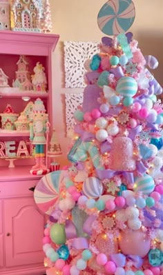 a pink and blue christmas tree decorated with balloons