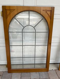 an arched wooden door with glass panels