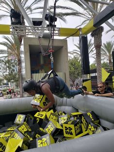 a man is climbing on an inflatable structure