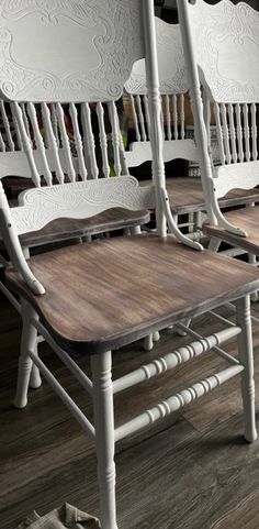 three white chairs with wooden seats on top of wood flooring next to each other