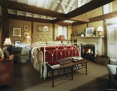 a bedroom with a bed and fireplace in it