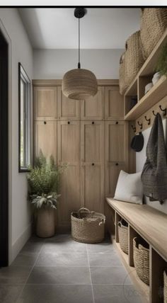 a long hallway with wooden shelves and baskets on the wall, along with hanging plants