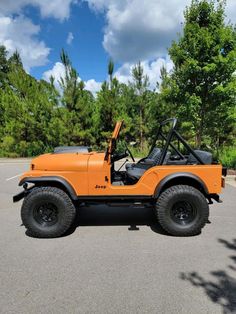 an orange jeep parked in a parking lot