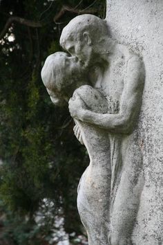 a stone statue holding a baby in its arms