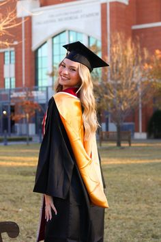 a woman wearing a graduation gown and cap