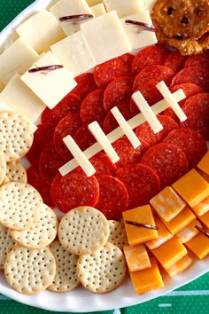 a football shaped cheese board with crackers and crackers