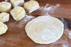 dough is being made on a wooden table