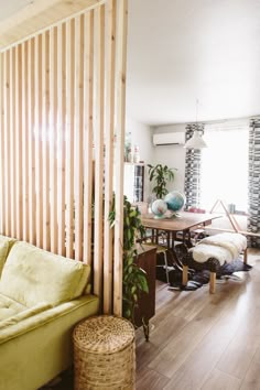 a living room filled with furniture and wooden slats