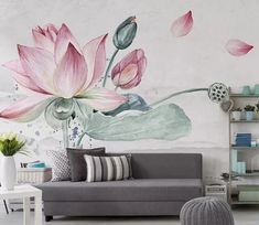 a living room filled with furniture and a large flower mural on the wall above it