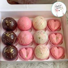 a box filled with pink and white chocolates