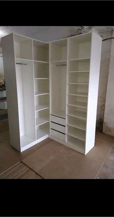 an empty room with white shelves and no one in the room or there is something on the floor