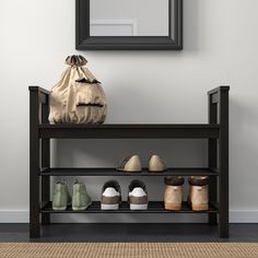 there is a shoe rack with many pairs of shoes on it next to a mirror