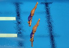 two swimmers in the middle of a swimming pool