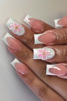 a woman's hand with french manies and pink flowers on the tip of their nails