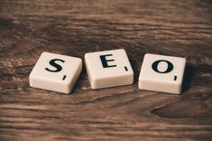 the word seo spelled out in small blocks on a wooden table