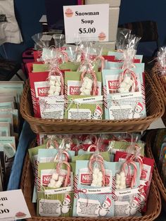 two baskets filled with candy and candies on top of each other in front of a sign that says snowman shop $ 5 00