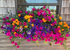 a window box filled with lots of colorful flowers