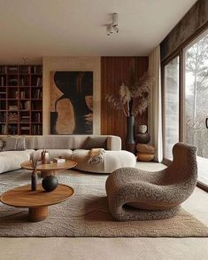 a living room filled with lots of furniture next to large windows and bookshelves