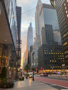 a city street with tall buildings in the background