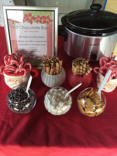 an assortment of hot chocolates and marshmallows in front of a crock pot