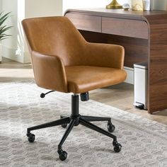 a brown leather office chair sitting on top of a rug in front of a desk