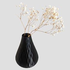 a black vase with white flowers in it