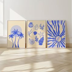 three blue and white paintings on the wall in an empty room with hard wood flooring