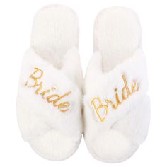 a pair of white slippers with the word bride written on one side and gold lettering on the other