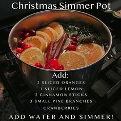 a pot filled with orange slices and cranberries