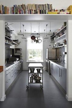 a kitchen with stainless steel appliances and lots of books