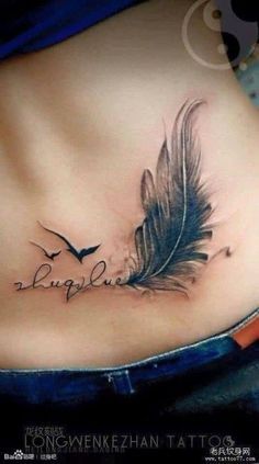 a woman's stomach with a feather tattoo on it