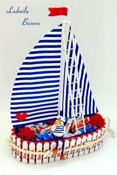 a toy sailboat with red, white and blue decorations