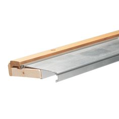 a piece of wood is attached to the back of a metal shelf with a wooden handle