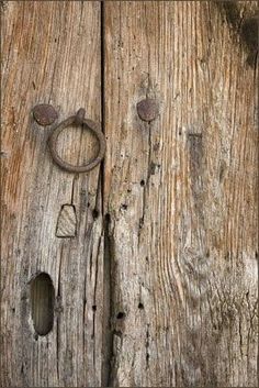 an old wooden door with two metal handles