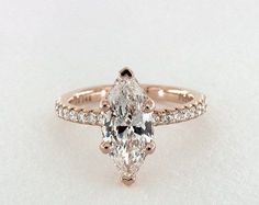 a pear shaped diamond ring with pave set shoulders