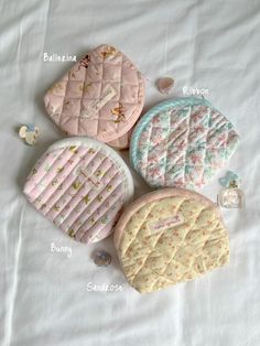 four cookies sitting on top of a bed next to each other with words written in them