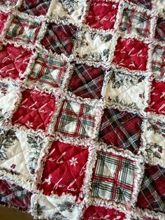 a red and white quilt on top of a table