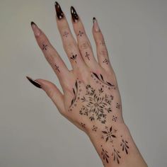 a woman's hand with black and white designs on it