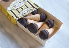 an open box of chocolate covered ice cream cones