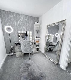 a room with a mirror, desk and chair in it