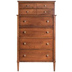 a wooden dresser with four drawers and three pulls on the bottom drawer, against a white background