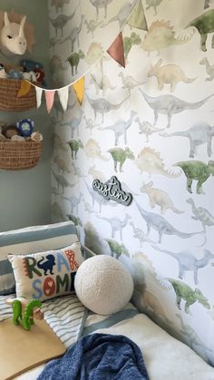 a child's bedroom decorated with dinosaur wallpaper