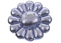 a silver flower shaped object on a white background